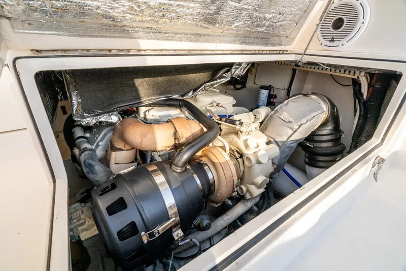 Slide: The Image of Engine compartment of a 2002 Cabo 35 Flybridge boat, showcasing detailed mechanical components. - 30