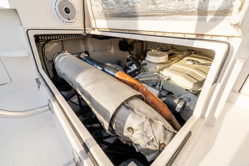 Slide: The Image of Engine compartment of a 2002 Cabo 35 Flybridge boat, showcasing mechanical components. - 31
