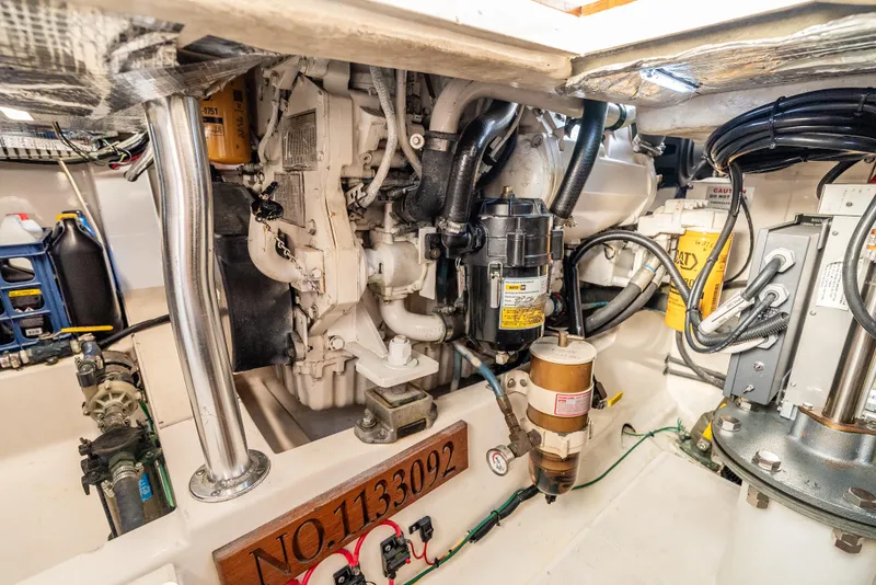 Slide: The Image of Engine room of a 2002 Cabo 35 Flybridge boat, showcasing mechanical components and equipment. - 33