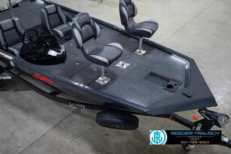 Slide: The Image of 2026 Lund 1775 Renegade boat with Mercury engine, gray interior, and steering console. - 11