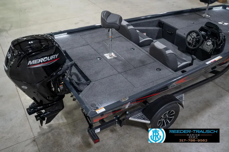 Slide: The Image of 2026 Lund 1775 Renegade boat with Mercury engine, displayed indoors on a trailer. - 12