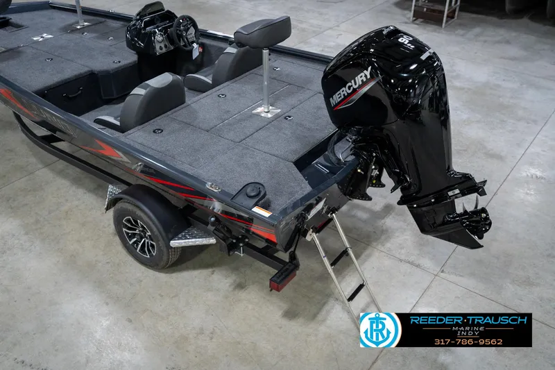 Slide: The Image of 2026 Lund 1775 Renegade boat interior in a showroom, featuring steering console and seating. - 13