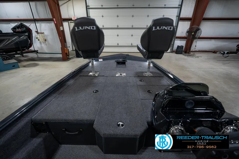 Slide: The Image of 2026 Lund 1775 Renegade boat interior with two seats in a garage setting. - 15