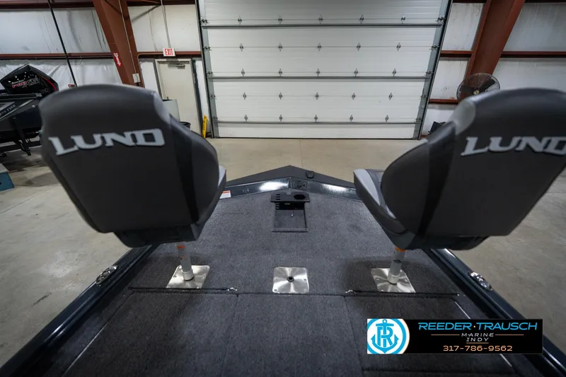 Slide: The Image of 2026 Lund 1775 Renegade boat interior with seating, displayed at Reeder-Trausch Marine showroom. - 16