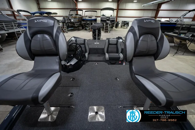 Slide: The Image of 2026 Lund 1775 Renegade boat interior with dual seats in a showroom. - 17