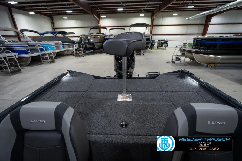 Slide: The Image of 2026 Lund 1775 Renegade boat interior with two seats in a garage setting. - 19