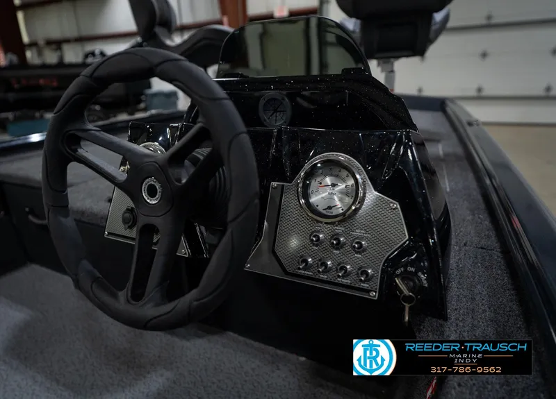 Slide: The Image of 2026 Lund 1775 Renegade boat interior in a showroom, featuring spacious deck and storage. - 20