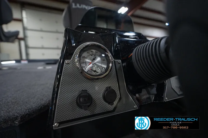 Slide: The Image of 2026 Lund 1775 Renegade boat interior with two seats and motor, in showroom. - 23