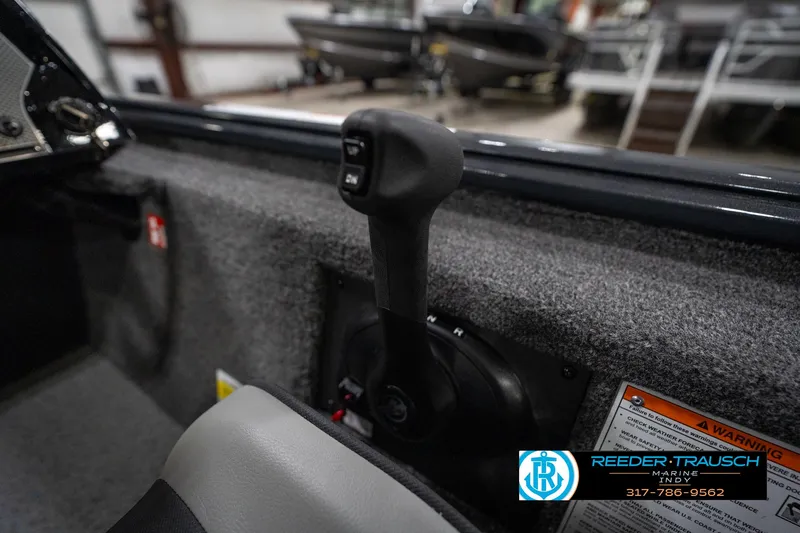 Slide: The Image of 2026 Lund 1775 Renegade boat interior with open storage compartments in a showroom. - 24