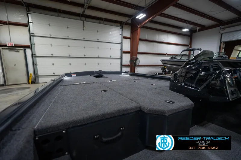 Slide: The Image of 2026 Lund 1775 Renegade boat interior with gray seating in showroom. - 27