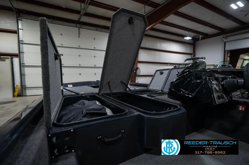 Slide: The Image of 2026 Lund 1775 Renegade boat dashboard with steering wheel and gauge in showroom. - 28