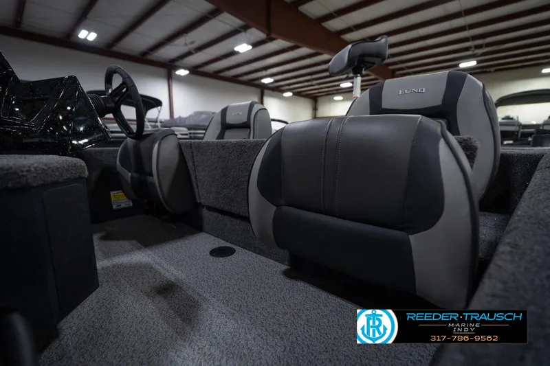 Slide: The Image of 2026 Lund 1775 Renegade boat interior with control lever and warning label. - 31