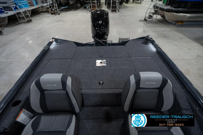 Slide: The Image of 2026 Lund 1775 Renegade boat interior with LED lighting and carpeted flooring. - 33