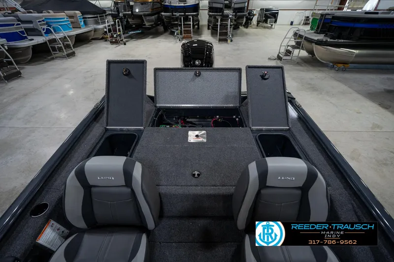 Slide: The Image of 2026 Lund 1775 Renegade boat interior with cup holder, Reeder-Trausch Marine logo visible. - 34