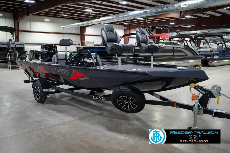 Slide: The Image of 2026 Lund 1775 Renegade boat in showroom, featuring sleek design and Mercury engine. - 4