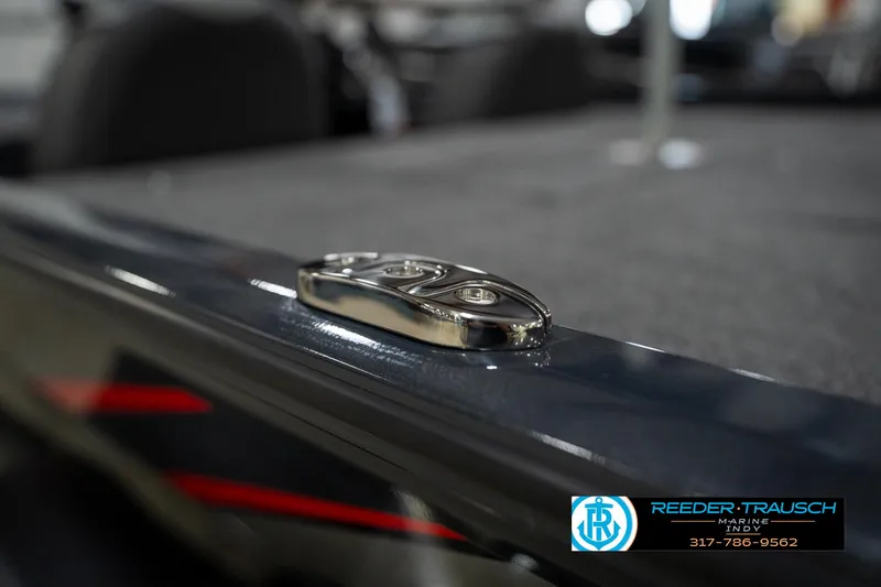 Slide: The Image of 2026 Lund 1775 Renegade boat on trailer in showroom, featuring sleek black design. - 46