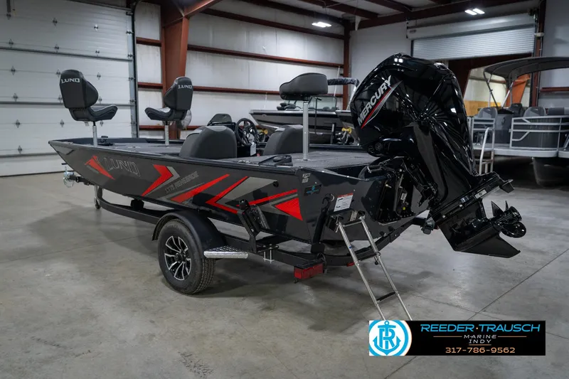 Slide: The Image of 2026 Lund 1775 Renegade fishing boat in showroom, featuring sleek design and Mercury engine. - 8