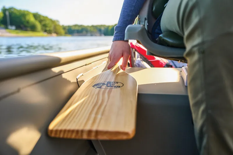Slide: The Image of Manufacturer Provided Image: Person holding a wooden paddle in a 2026 Tracker Grizzly 14 Jon boat on a lake. - 46