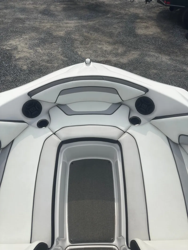 Slide: The Image of 2018 Yamaha AR195 boat interior with white cushioned seating and speakers. - 12