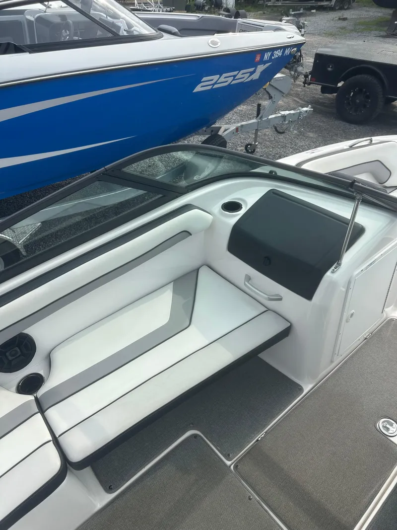Slide: The Image of 2018 Yamaha Boats AR195 interior with white seating and cup holders. - 15