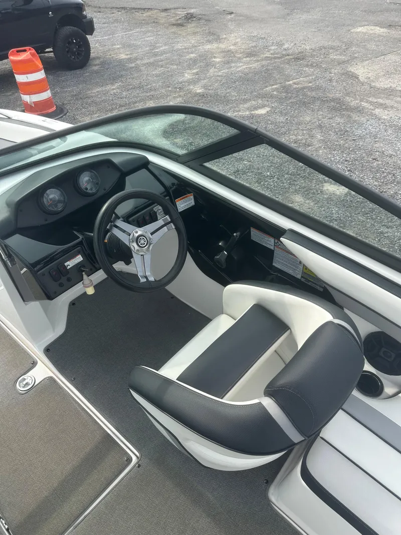 Slide: The Image of 2018 Yamaha AR195 boat cockpit with steering wheel and seating. - 17