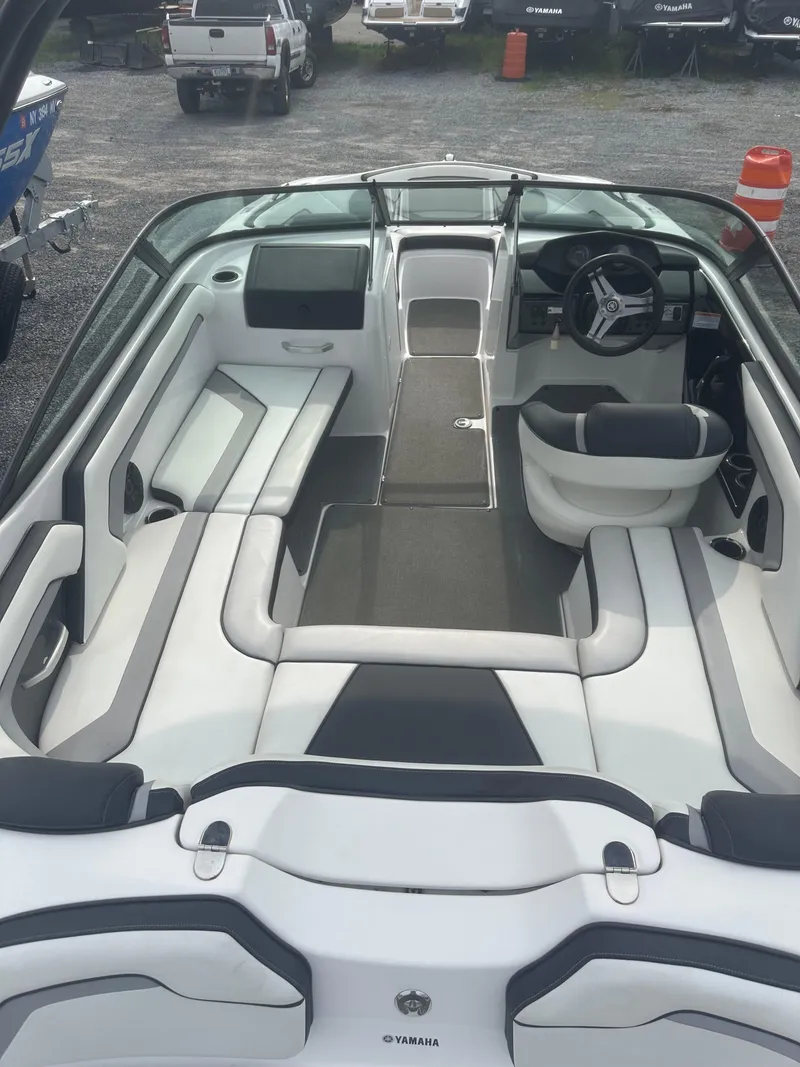 Slide: The Image of 2018 Yamaha Boats AR195 interior with sleek seating and modern dashboard design. - 18