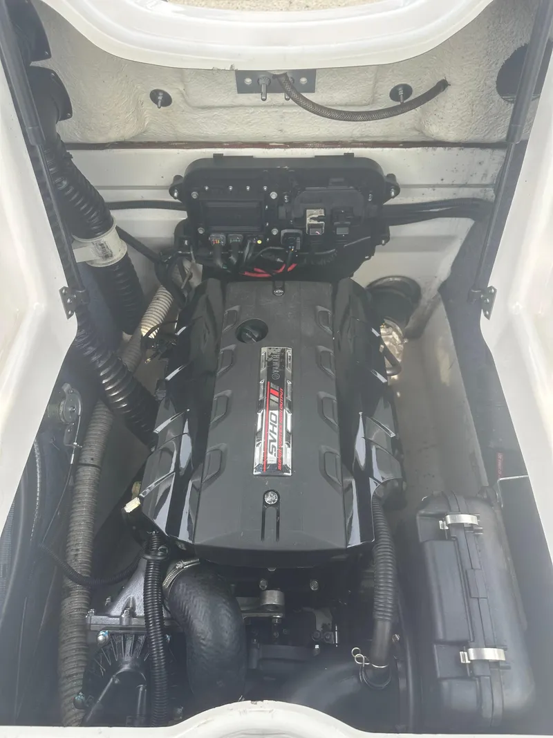 Slide: The Image of Engine compartment of a 2018 Yamaha Boats AR195, showcasing the powerful motor. - 19