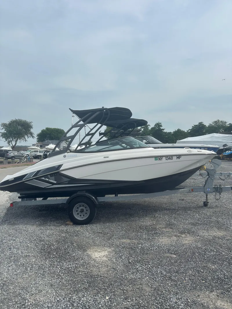 Slide: The Image of 2018 Yamaha Boats AR195 on trailer in parking lot, overcast sky. - 4