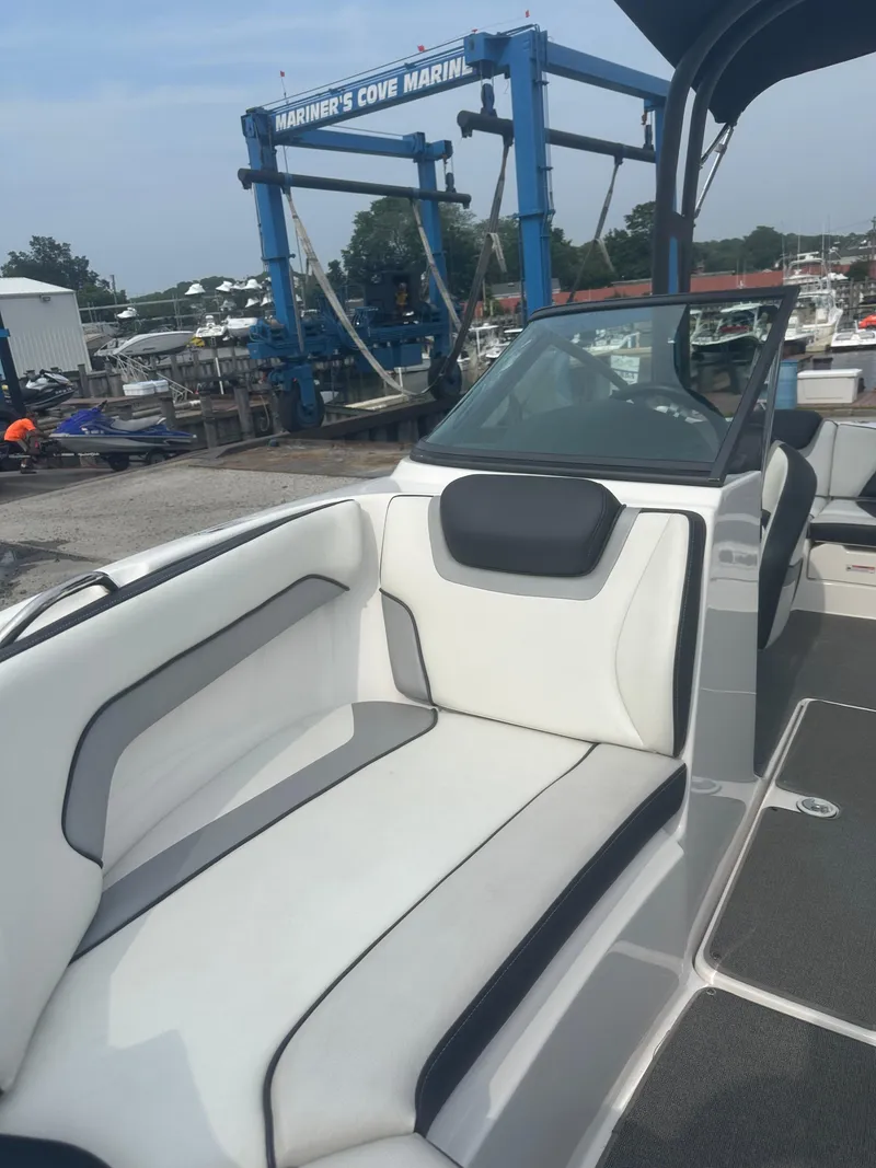 Slide: The Image of 2018 Yamaha AR195 boat interior at Mariner's Cove Marina, featuring white seating and windshield. - 9