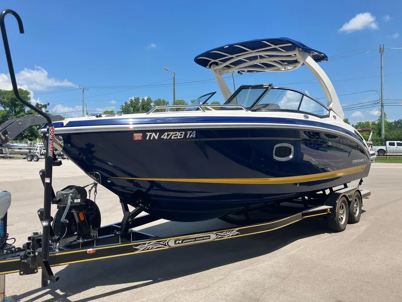 Slide: The Image of 2017 Chaparral 257 SSX boat on trailer, blue and white design, sunny day background. - 0