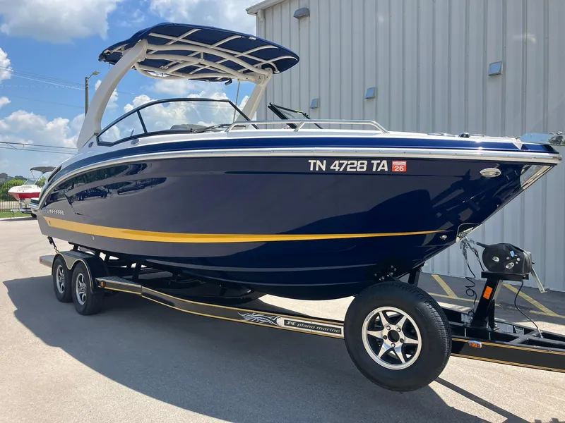 Slide: The Image of 2017 Chaparral 257 SSX boat on trailer, blue and yellow design, parked outdoors. - 1