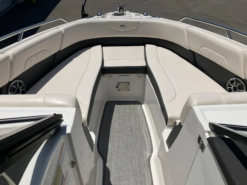 Slide: The Image of 2017 Chaparral 257 SSX boat interior with white seating and gray flooring. - 10
