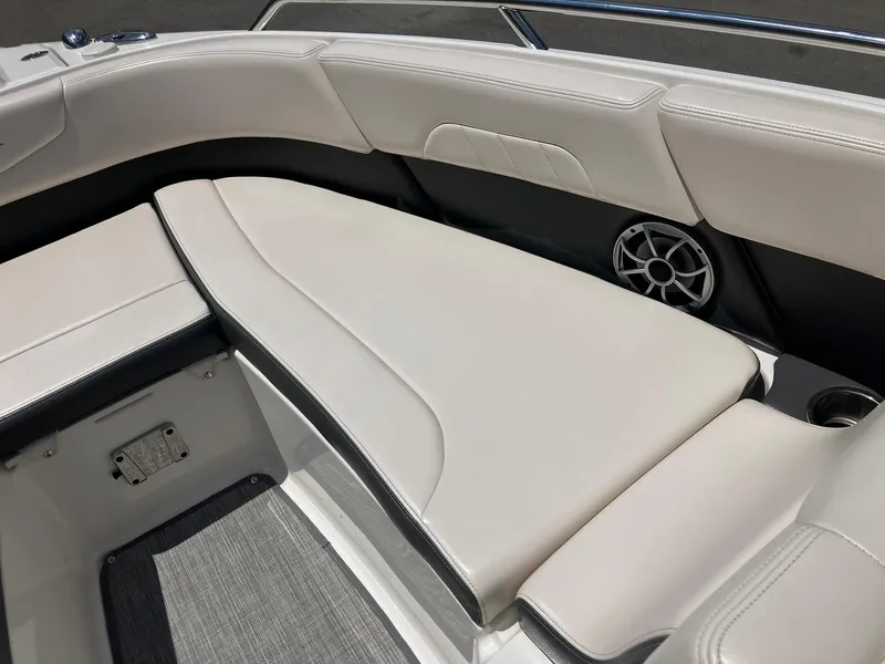 Slide: The Image of 2017 Chaparral 257 SSX boat interior with white cushioned seating and speaker. - 11