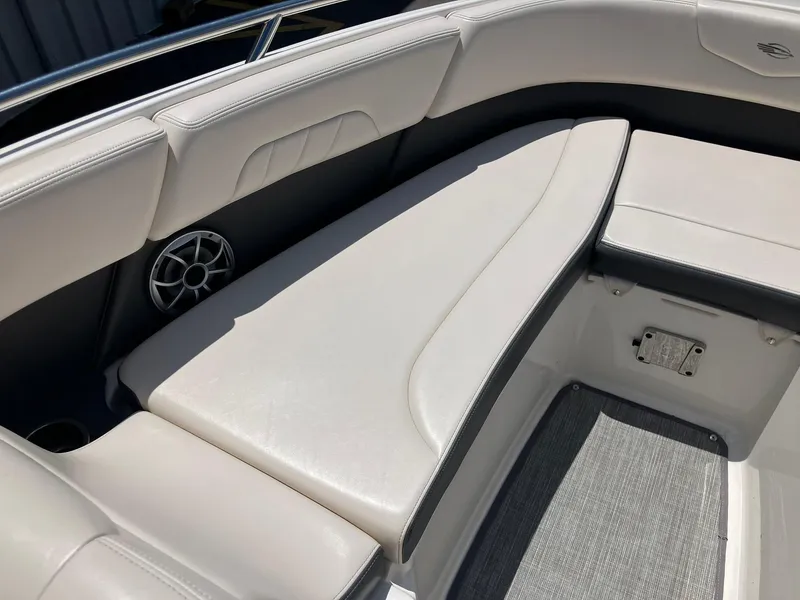 Slide: The Image of 2017 Chaparral 257 SSX boat interior with white cushioned seating and speaker. - 12