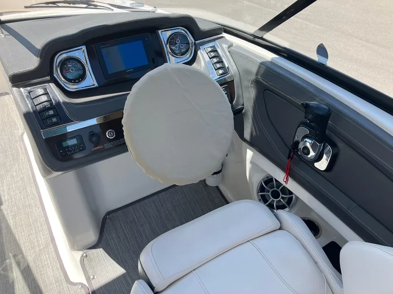 Slide: The Image of 2017 Chaparral 257 SSX boat dashboard with steering wheel and control panel. - 15