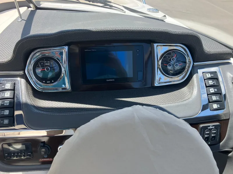 Slide: The Image of 2017 Chaparral 257 SSX dashboard with Garmin display and chrome-trimmed gauges. - 16