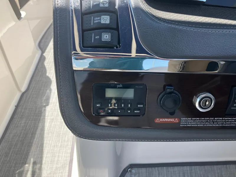 Slide: The Image of Control panel of a 2017 Chaparral 257 SSX boat with audio system and switches. - 17