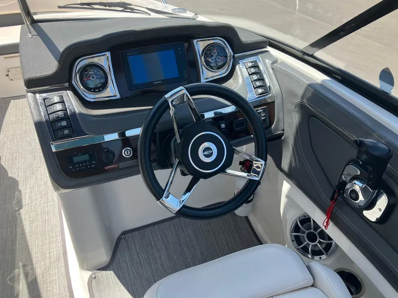 Slide: The Image of 2017 Chaparral 257 SSX boat dashboard with steering wheel and control panel. - 18