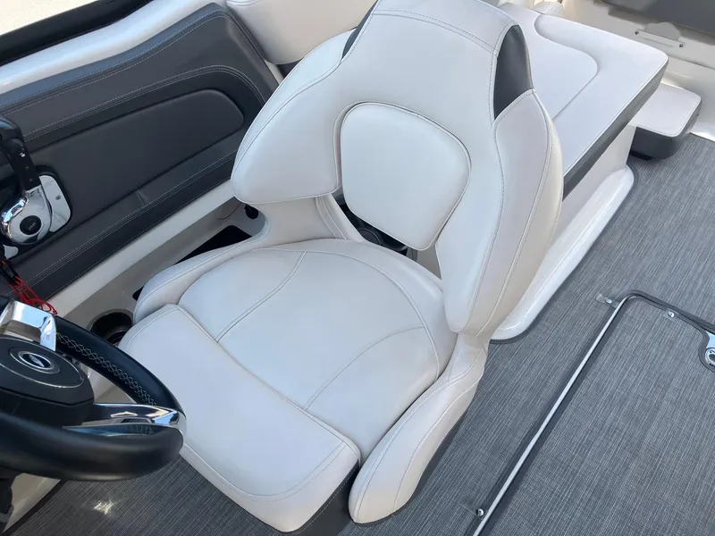 Slide: The Image of 2017 Chaparral 257 SSX boat interior with white captain's chair and steering wheel. - 19
