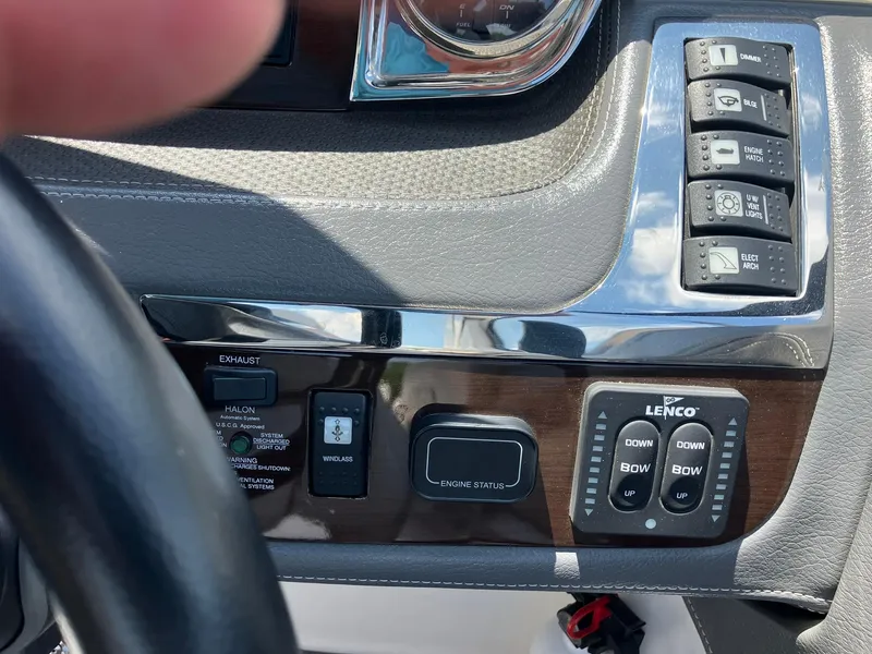 Slide: The Image of Control panel of a 2017 Chaparral 257 SSX boat with various switches and buttons. - 25