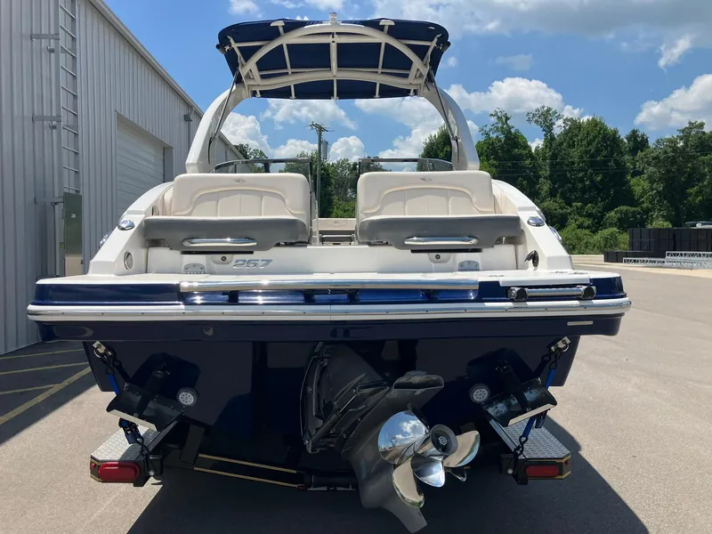 Slide: The Image of 2017 Chaparral 257 SSX boat, rear view, parked outdoors under blue sky. - 3