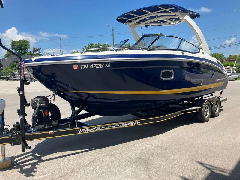 Slide: The Image of 2017 Chaparral 257 SSX boat on trailer, blue and white design, parked outdoors. - 5