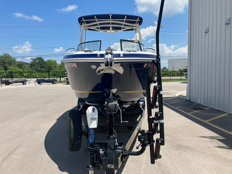 Slide: The Image of 2017 Chaparral 257 SSX boat on trailer, parked outdoors under blue sky. - 6