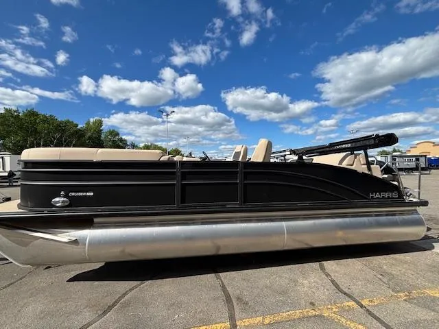 The Image of 2025 Harris CRUISER 230 SLDH pontoon boat parked under a clear blue sky. - 1