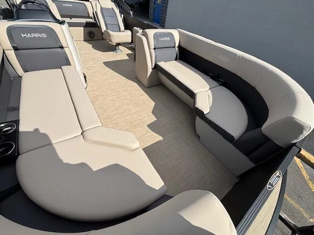 Slide: The Image of 2025 Harris CRUISER 230 SLDH pontoon boat interior with beige seating and spacious layout. - 10