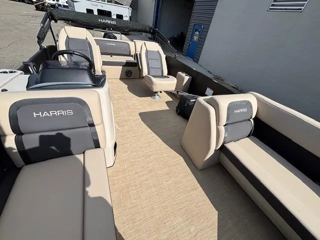 Slide: The Image of 2025 Harris CRUISER 230 SLDH pontoon boat interior with beige seating and steering console. - 11