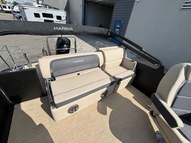 Slide: The Image of 2025 Harris CRUISER 230 SLDH pontoon boat interior with beige seating and modern design. - 14