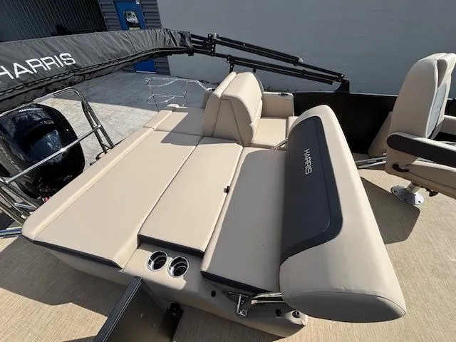 Slide: The Image of 2025 Harris CRUISER 230 SLDH boat interior with beige seating and cup holders. - 16