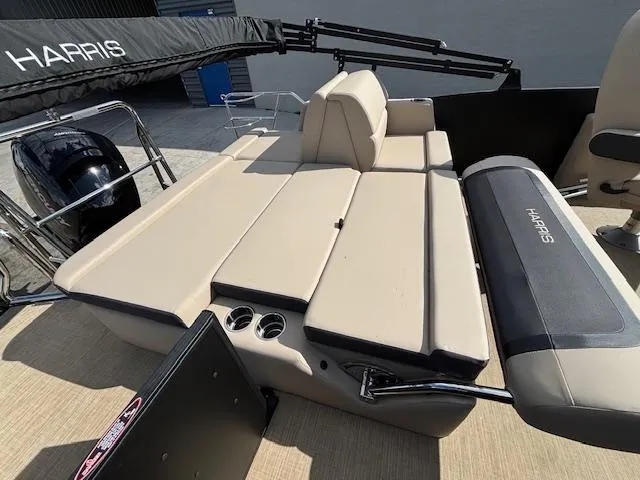 Slide: The Image of 2025 Harris CRUISER 230 SLDH boat interior with beige seating and cup holders. - 17
