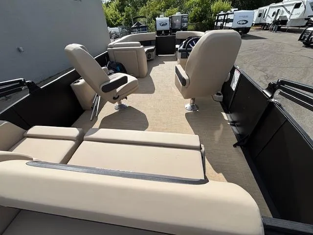 Slide: The Image of 2025 Harris CRUISER 230 SLDH pontoon boat interior with beige seating and spacious layout. - 20